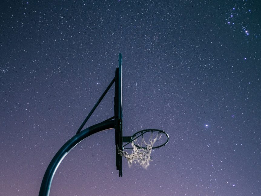 Basketball hoop with heavens in the background
